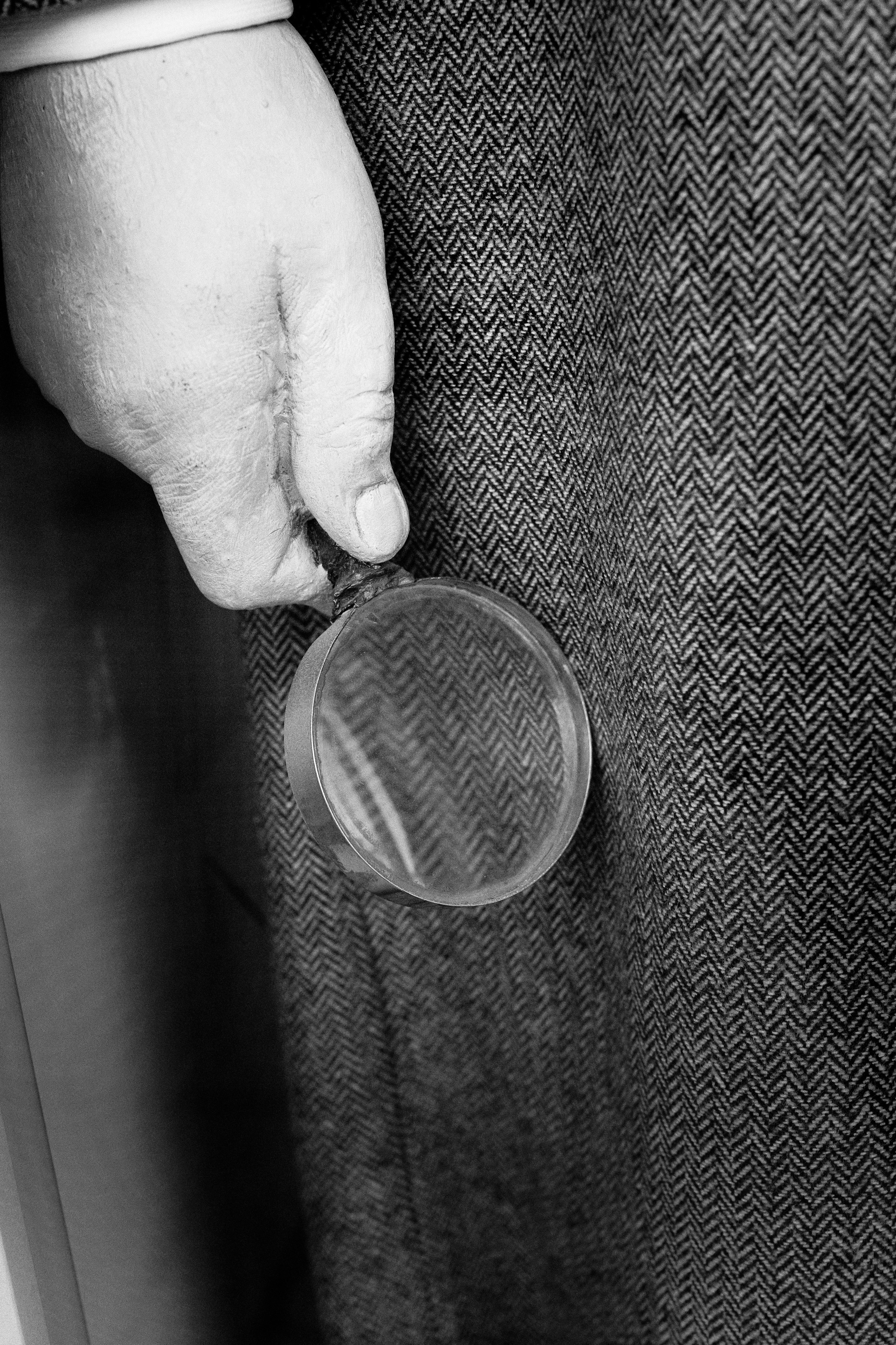 Inspector examining woven fabric under magnification